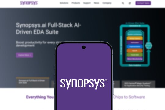 Synopsys Logo is displayed on a modern smartphone, tools and services to the semiconductor design and manufacturing industry, website of Synopsys in the background, processors, ai, cloud
