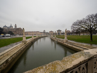 Historical canal in Padova, Veneto, Italy, adorned with charming monuments, showcasing the rich...