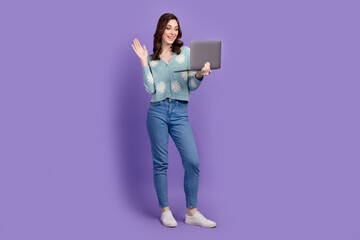 Full length photo of cute adorable woman wear flower print cardigan waving arm hi talking modern gadget isolated purple color background © deagreez