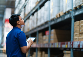 Asian warehouse employees who are confident in large warehouses, distribution centers, logistics systems. logistics system distribution center.