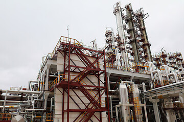 Fototapeta na wymiar Industrial zone, the equipment of oil refining, industrial pipelines of an oil and gas plant