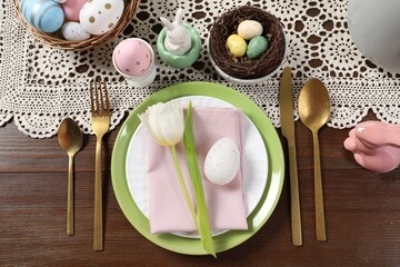 Festive table setting with beautiful tulip, flat lay. Easter celebration
