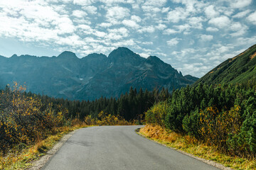 Fototapeta premium country road and green mountains in summer.Tatra National Park in Poland. Famous mountains lake Morskie oko or sea eye lake In High Tatras. Five lakes valley. 