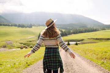 Beautiful woman walking in the field at sunny summer day. Nature, vacation, relax and lifestyle....