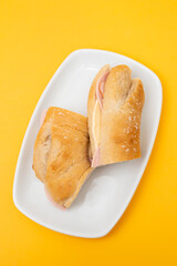 a spanish rosca de jamon serrano, ham sandwich, on a white plate