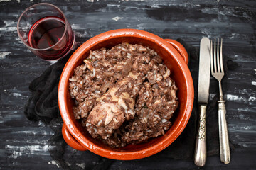 Typical portuguese dish chicken with rice in ceramic dish.