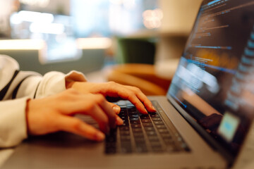 Close-up of hands working on a laptop keyboard. Young woman using laptop computer. Freelance, online course. Shopping online. Cyber security concept