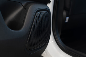 Obraz na płótnie Canvas Sound column of multimedia system in rear door of passenger car close-up on blurred background