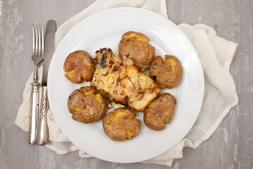 Traditional portuguese cousine, cod fish with potatoes and onions, covered with oil.