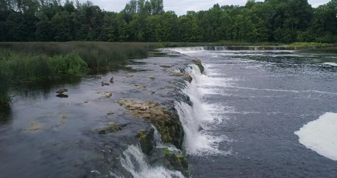 Aerial drone slow motion shot of Europe's widest waterfall Venta rapid, Kuldīga, Latvia