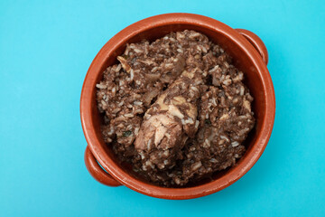 Typical portuguese dish chicken with rice in ceramic dish.