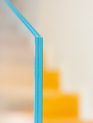 Detail with selective focus of the section of a tempered glass balustrade.