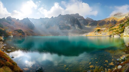 Fototapeta na wymiar Mysterious mountain lake with turquoise water in the autumn day. Zen lake. Beautiful reflection of mountains and autumn foliage Panoramic view of mountain lake.