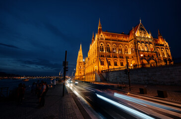 The Hungarian Parliament Building on the bank of the Danube in Budapest at night time.