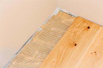 Installation of oak parquet with adhesive.