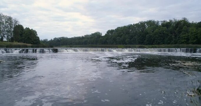 Aerial drone slow motion shot of Europe's widest waterfall Venta rapid, Kuldīga, Latvia