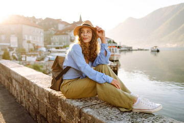 Young female tourist enjoys the view of the city. Europe travel. Lifestyle, vacation, tourism,...