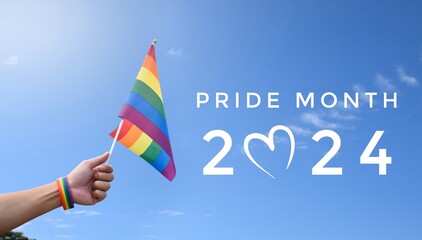 Pride Month 2024 on rainbow flags raising background, concept for celebrations of LGBTQAI people in...