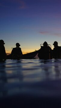 Group of divers preparing for a dive on a beach in Thailand