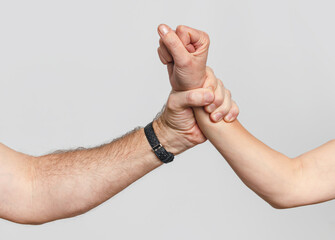 Man's hand grabbed a woman's hand. Concept of gender-based violence and mistreatment of women.