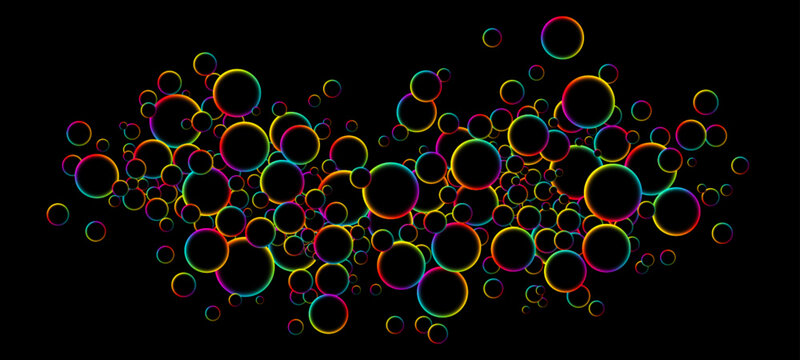Colorful rainbow random flying glowing circles, spheres or bubbles. Luminous floating balls shine with rainbow colors on black background. Fluorescent circle particles dynamic flow. Vector background