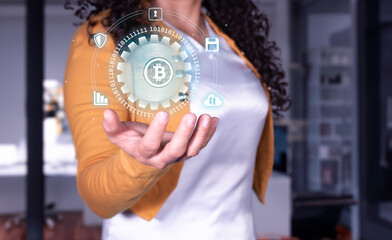 Businesswoman shows us how to buy and sell bitcoin safely. network concept. hologram in hand