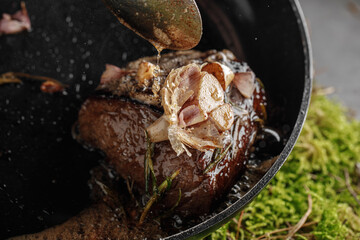 Fried fillet of beef with garlic and rosemary in a pan