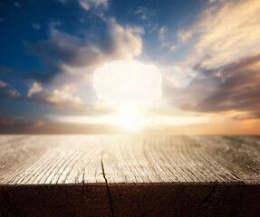 Nuclear explosion mushroom cloud against sunset sky through the window