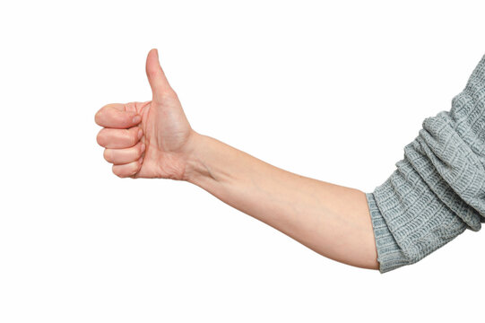 Thumbs up sign. Female hand with thumb up isolated on white background. Studio photo.