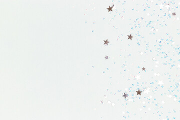 Silver stars and crystals confetti on a blue background. Glowing concept with place for text.