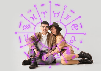 Fashionable young couple in autumn clothes on light background