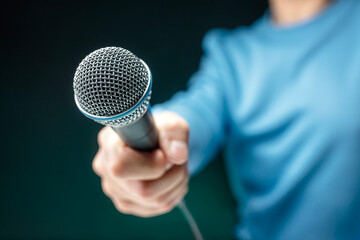 Reporter recording interview with microphone