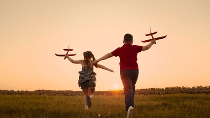 happy boy girl child play airplane pilot sunset, children family dream flying, running playing with...