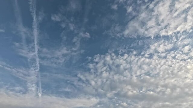 Planes in the cloudy sky leaving white contrails