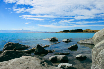 Peaceful Lake Tekapo, New Zealand, South Island. Beautiful lanscape scenario of a lake with calm am...