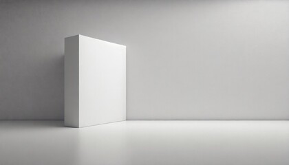 A solitary white cube stands against a textured grey wall on a smooth surface.