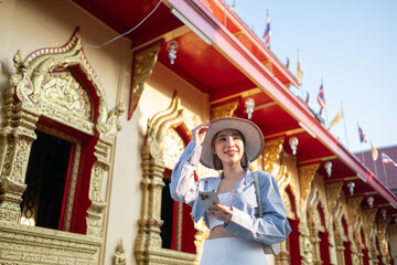 Traveler Asian woman traveling and walking in Bangkok Chiang Mai Temple, Thailand, backpacker female feeling happy spending relax time in holiday trip
