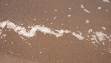 beach waves foam on beach sand