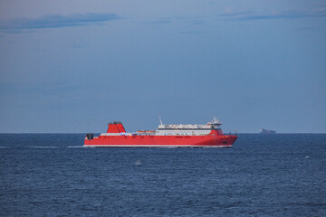 Mega LNG powered car, passengers pax and cargo transporter ro-ro ferry ship cruiseship cruise liner arrival into Marseille port, France with harbor and coastal skyline