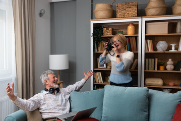 Simple living. Elderly retired couple enjoying their retirement, reminiscing entertaining in their...