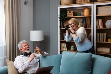 Simple living. Elderly retired couple enjoying their retirement, reminiscing entertaining in their...