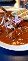 Goulash with Dumplings is a hearty and flavorful Central European dish. It consists of tender beef chunks, slow-cooked in a savory broth infused with sweet paprika, cumin, coriander, and marjoram. The