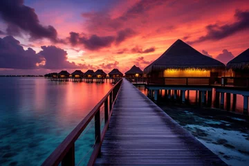 Keuken spatwand met foto Maldives at a resort on the island at sunset. © Wararat