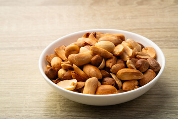 Close up Air fryer Roasted peeled peanuts in white plate.rich in protein,fat,and fiber