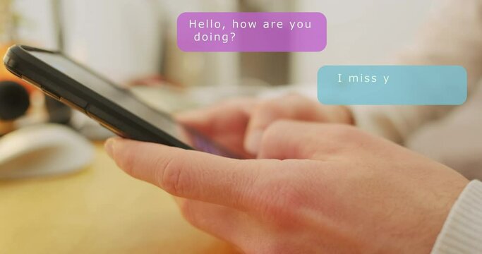 Man corresponds in an online chat with a loved one, bloop pop-up messages from his wife, love emoticons. Close-up of hands holding a smartphone.