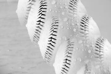 Baseball art shows multiple wet balls as multiple exposure in black and white for sports concept.
