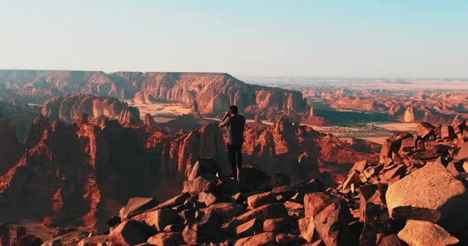 Man on the edge of a cliff in Al Ula, Saudi Arabia