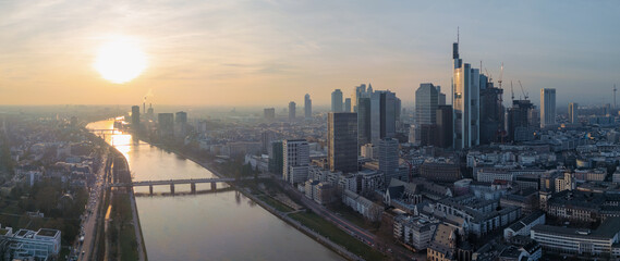 Panorama of Frankfurt am Main with the skyscrapers and the sun setting over the river main