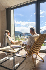 couple sitting in house with a view of mountain