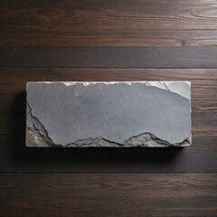 gray stone slab plaque on wooden surface, simple background, minimalist